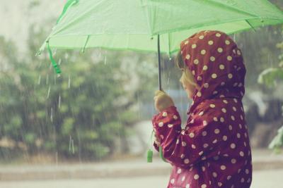 Pige i regnvejr med paraply